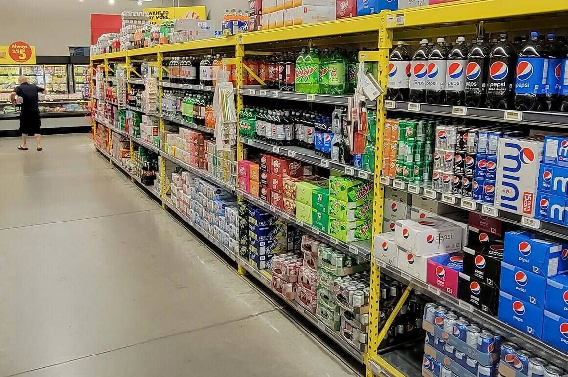 A customer walks down a grocery store’s drinks aisle in Newcastle, Ont. on Thursday July 13, 2023. The Canadian Cancer Society and Health Canada are reviewing the World Health Organization’s classification of aspartame as “possibly carcinogenic.” THE CANADIAN PRESS/Doug Ives