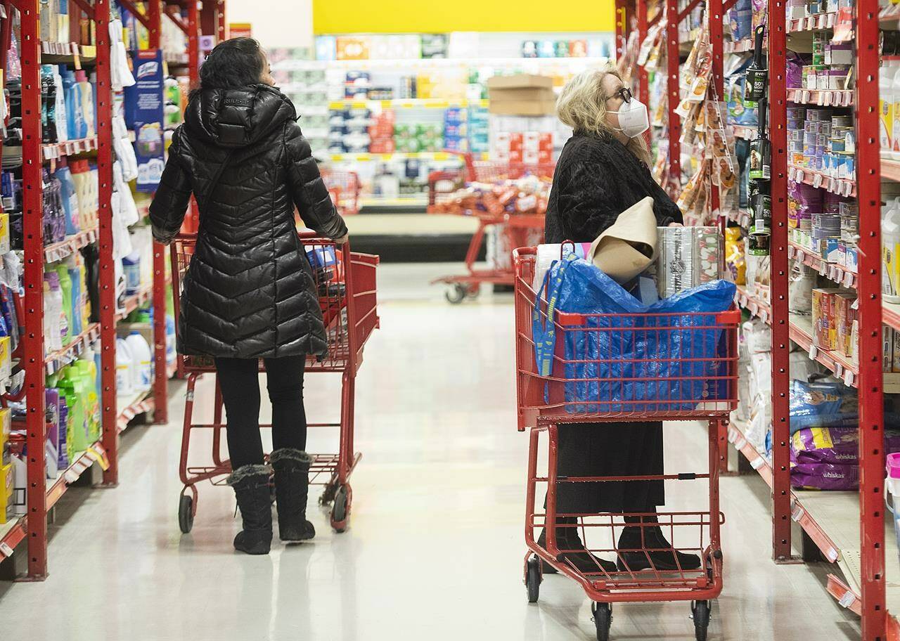 People shop in a grocery store in Montreal, Wednesday, November 16, 2022. The picture of how the economy fared in May will become a little clearer with a pair of reports from Statistics Canada this week.THE CANADIAN PRESS/Graham Hughes
