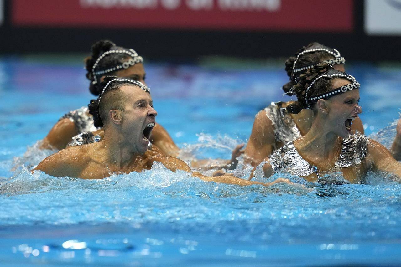Bill May, left, part of the United States team, competes in the team acrobatic of artistic swimming at the World Swimming Championships in Fukuoka, Japan, Saturday, July 15, 2023. Largely unnoticed by the general public, men have been participating in artistic swimming, formerly known as synchronized swimming, for decades. (AP Photo/Nick Didlick)
