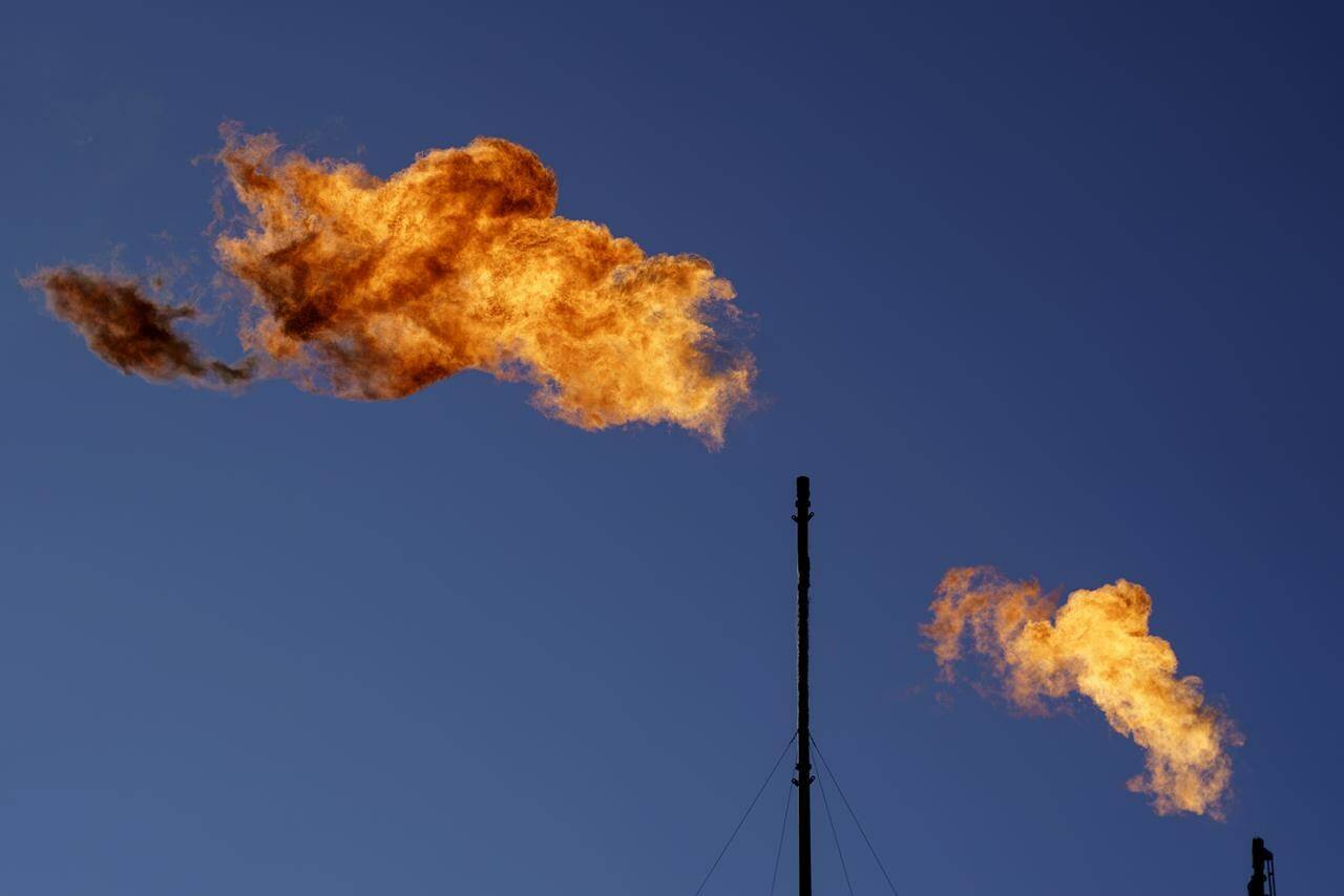Flares burn off methane and other hydrocarbons at an oil and gas facility in Lenorah, Texas, Friday, Oct. 15, 2021. New research on Canada’s methane emissions concludes it would be much cheaper for the energy industry to meet reduction targets for the potent greenhouse gas than it would be to pay carbon taxes on it. THE CANADIAN PRESS/AP, David Goldman