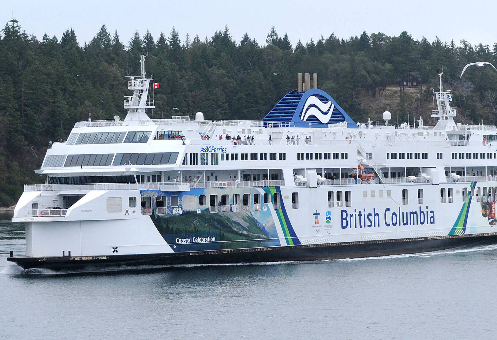 Passengers stand on the top outside deck of the BC Ferries’ vessel Coastal Celebration in Active Pass during a sailing from Tsawwassen to Swartz Bay. (Black Press Media Photo File)