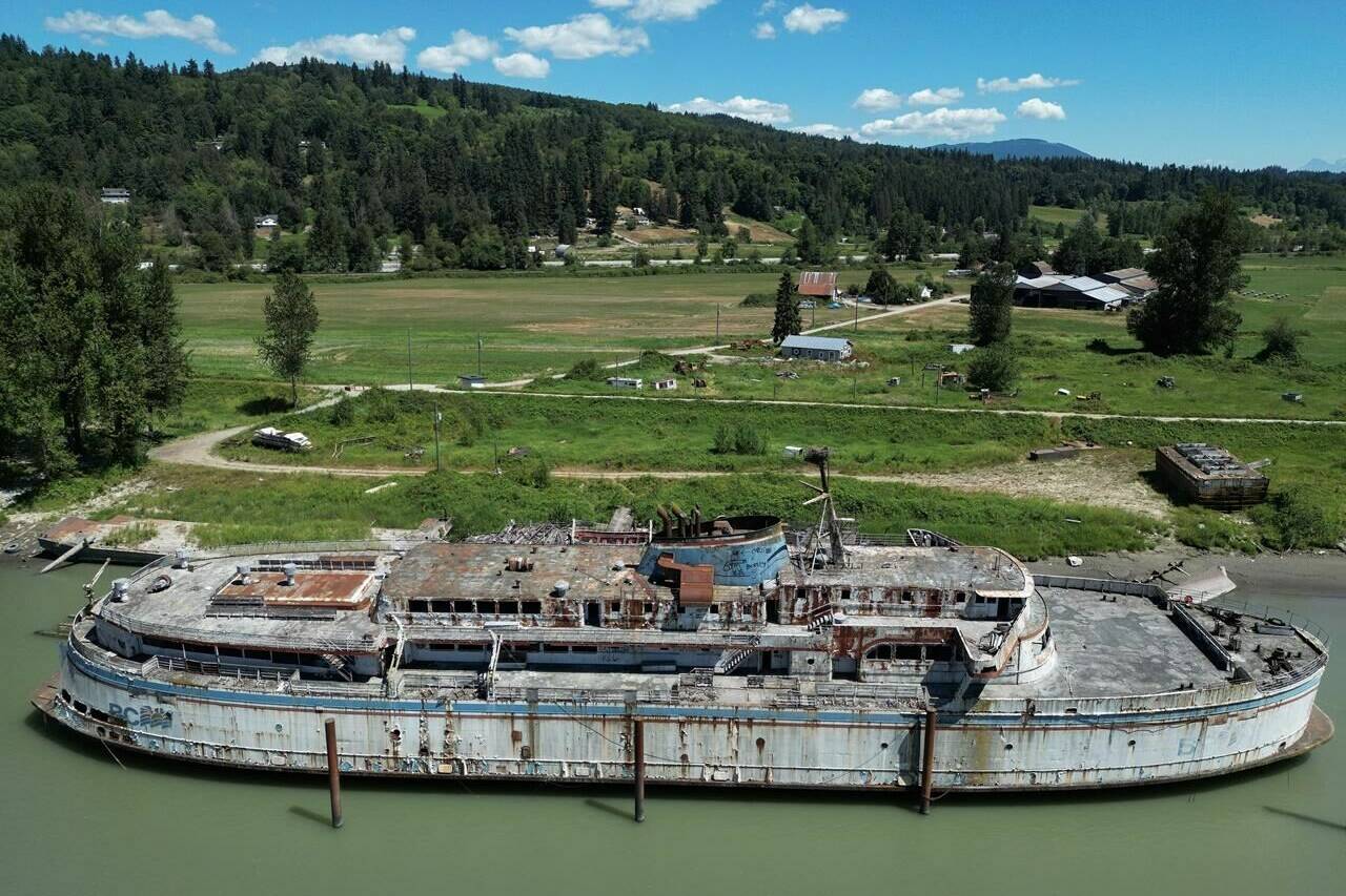 The retired BC Ferries vessel Queen of Sidney, that was in operation from 1960 to 2000, is seen moored on the Fraser River, in Mission, B.C., on Tuesday, July 18, 2023. The Canadian government’s inventory of more than 1,700 wrecked, abandoned or hazardous boats includes a U.S. warship, a derelict floating McDonald’s known as the McBarge, a human-smuggling ship and an old BC Ferries vessel rotting on the Fraser River. THE CANADIAN PRESS/Darryl Dyck