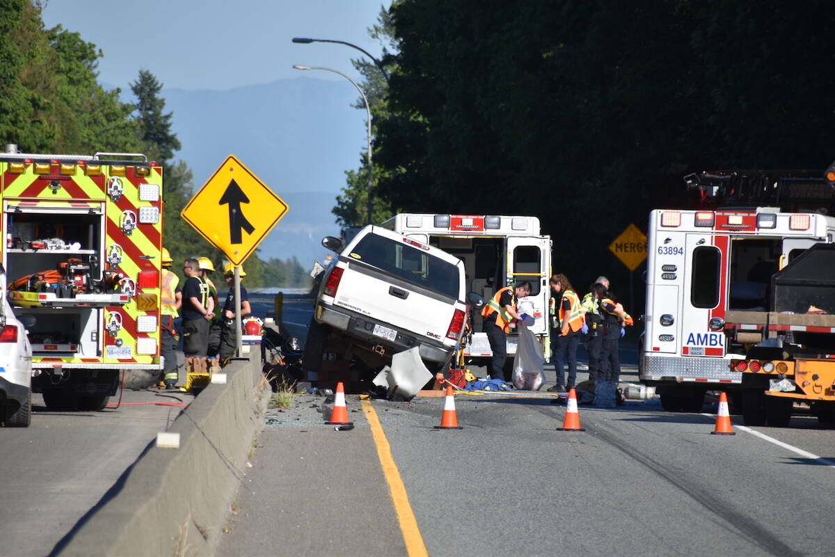 A motorcycle rider ended up under a pickup truck as a result of a crash near 264th Street on Highway 1 on Wednesday, July 11, witnesses said. (Curtis Kreklau/South Fraser News Services)