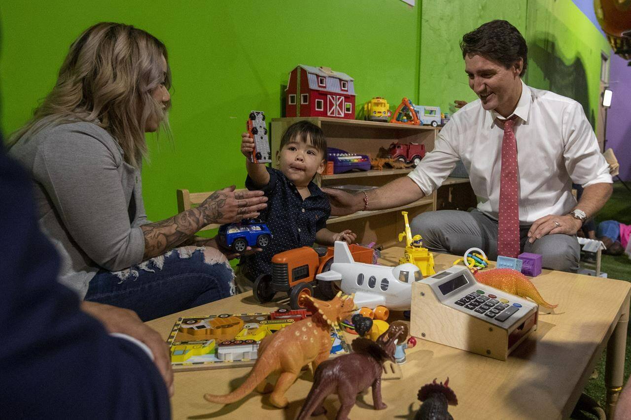 Prime Minister Justin Trudeau speaks two-year-old River Beatty, and his mother Catherine at the Boys and Girls clubs in Kingston, Ont., on Thursday July 20, 2023. Families eligible for the Canada Child Benefit are receiving their July payments today, which includes a hefty cost-of-living adjustment. THE CANADIAN PRESS/Lars Hagberg