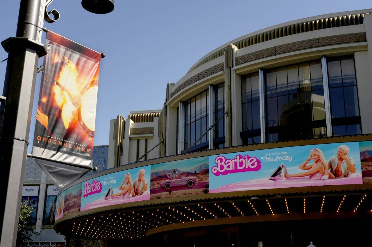 Advertisements for the films “Oppenheimer” and “Barbie” appear at AMC Theaters at The Grove on Thursday, July 20, 2023, in Los Angeles. (AP Photo/Chris Pizzello)