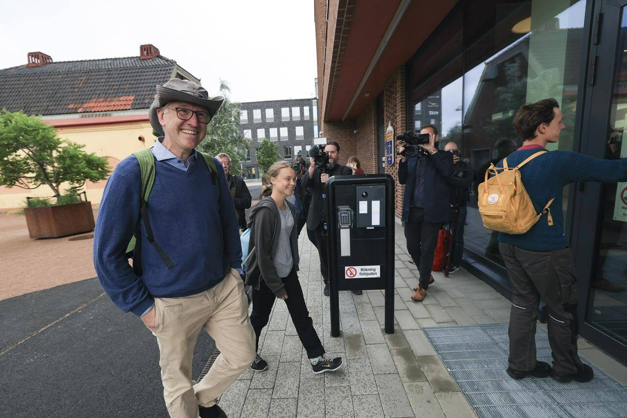 Climate activist Greta Thunberg, centre, arrives at Malmo district court on a charge of disobeying police at a protest in southern Sweden last month, in Malmo, Sweden, Monday, July 24, 2023. Thunberg was charged because she refused to comply with police orders to leave the scene during the protest, according to Swedish Prosecution Authority spokeswoman Annika Collin and a statement from prosecutors. (Andreas Hillergren/ TT News Agency via AP)