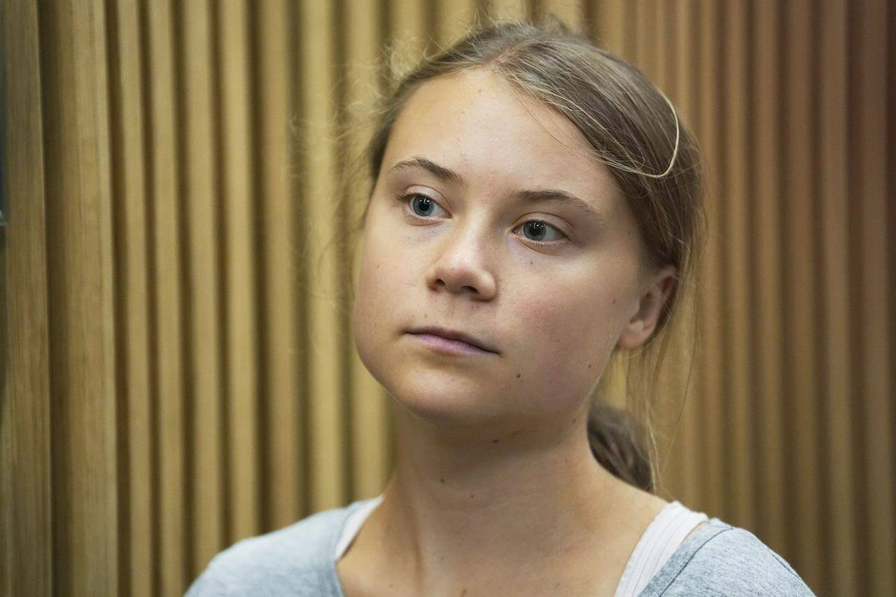 Climate activist Greta Thunberg waits for a hearing in a court in Malmo, Sweden, Monday, July 24, 2023. Thunberg appeared in court on Monday charged with disobeying law enforcement in connection with a protest in Malmo in southern Sweden last month. (AP Photo/Pavel Golovkin)