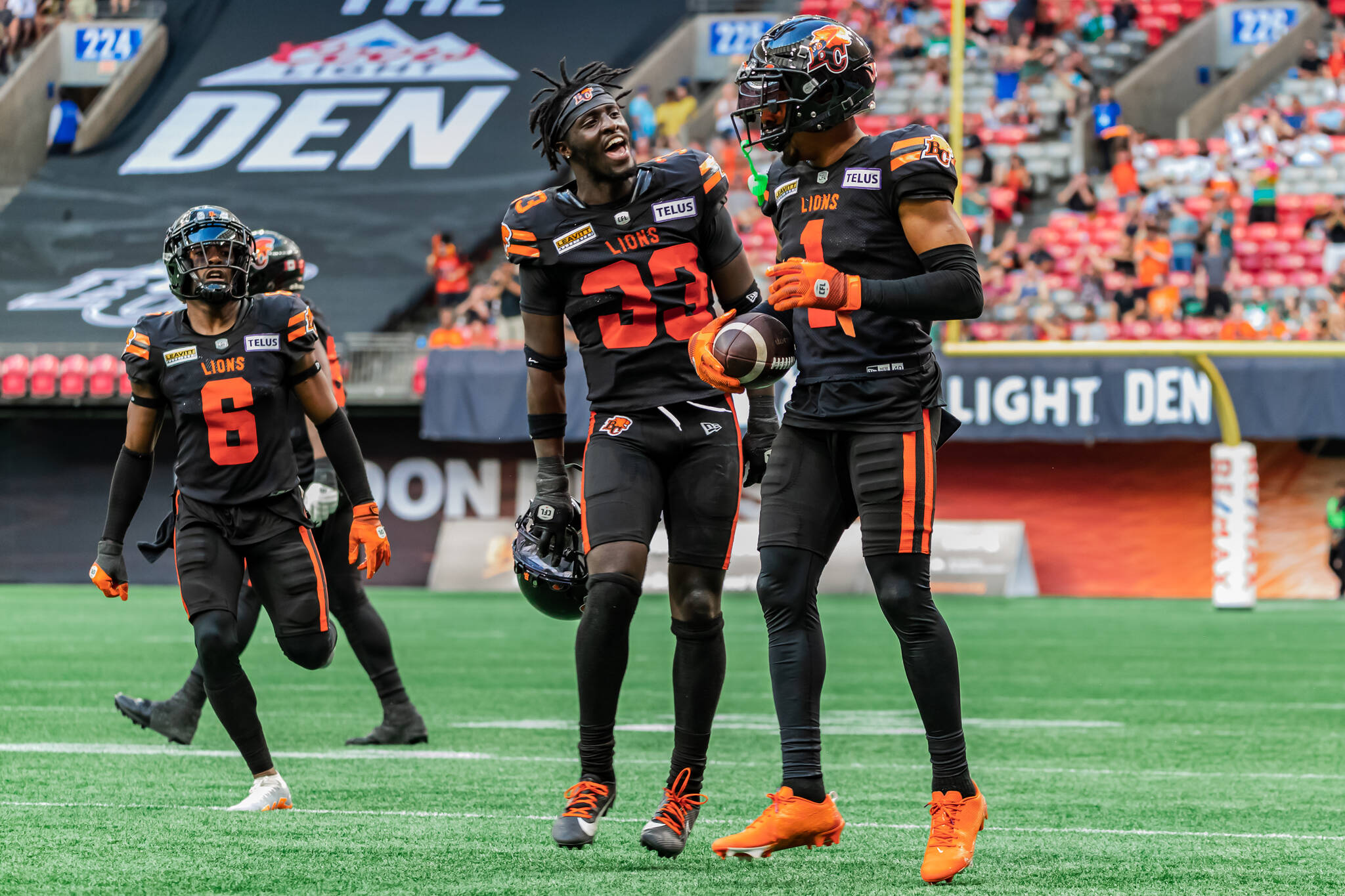 TJ Lee (6) and Manny Rugumba (33) celebrate with Gary Peters (1) after his interception during the Lions 19-9 win over the Saskatchewan Roughriders at BC Place Stadium on Saturday. Steve Chang, B.C. Lions
