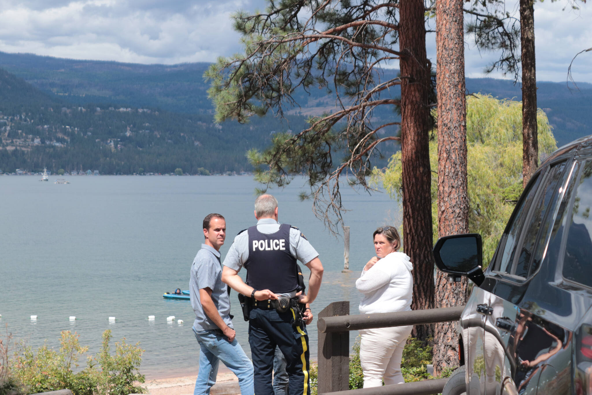 RCMP officers were at Hurlburt Park Wednesday, July 26, 2023, two days after a fishing boat capsized on Okanagan Lake and the man driving the boat did not surface. (Brendan Shykora - Morning Star)