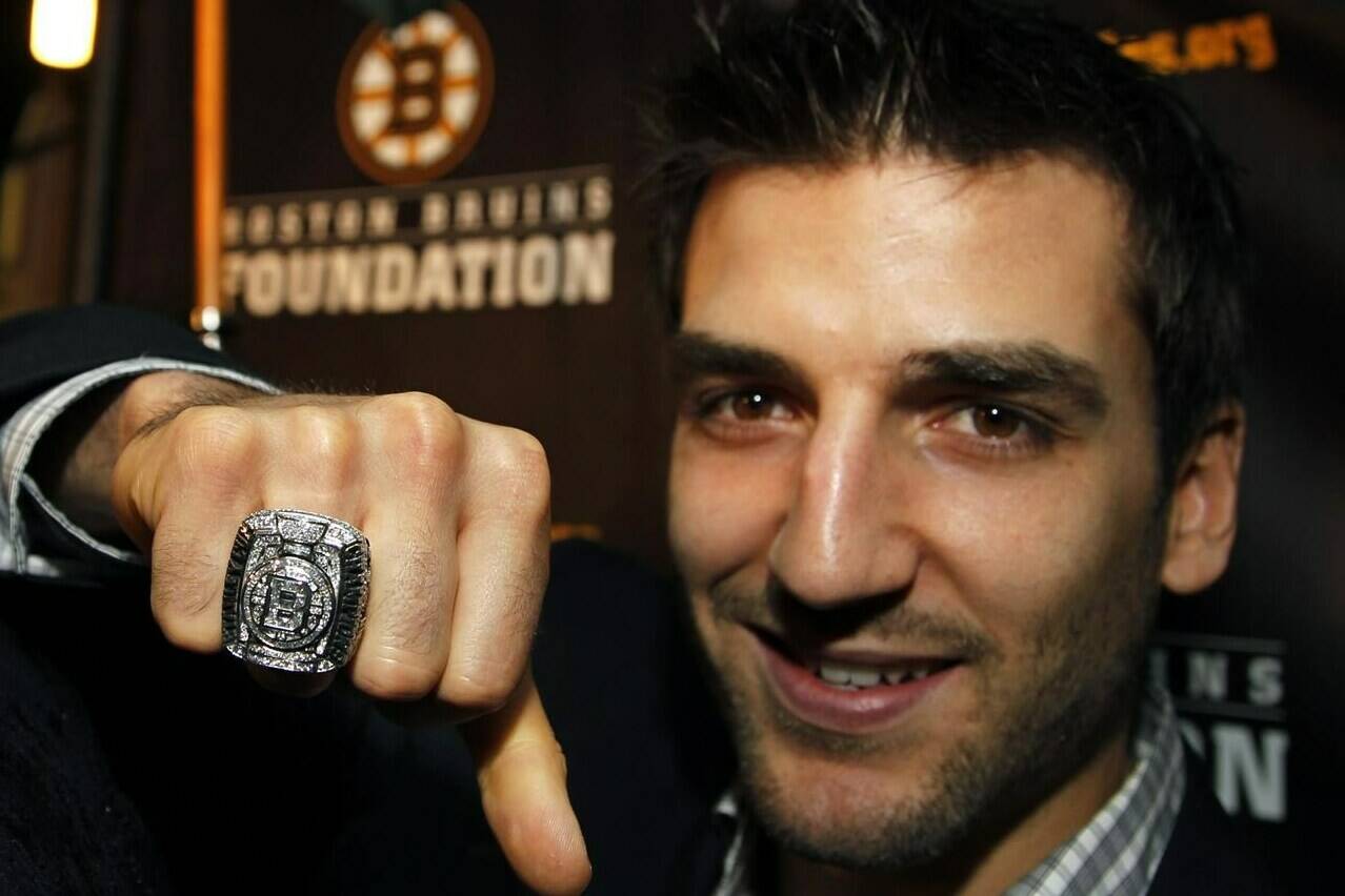 FILE - Boston Bruins NHL hockey forward Patrice Bergeron displays his Stanley Cup Championship ring to members of the media outside the Boston Harbor Hotel, in Boston, Tuesday, Oct. 4, 2011, following the unveiling of the rings during ceremonies for the hockey team. Bruins forward Patrice Bergeron has retired. The five-time Selke Trophy winner announced Tuesday, July 25, 2023, that he will not return for a 20th season with the only team he has ever played for. The Bruins captain said he is leaving with no regrets. (AP Photo/Steven Senne, File)
