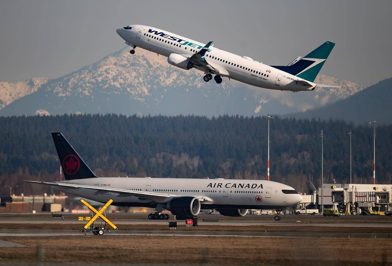 Figures from an aviation data firm show Canada’s two biggest airlines see a far higher proportion of their flights delayed compared with many of their peers abroad. An Air Canada flight taxis to a runway as a WestJet flight takes off at Vancouver International Airport, in Richmond, B.C., on March 20, 2020. THE CANADIAN PRESS/Darryl Dyck