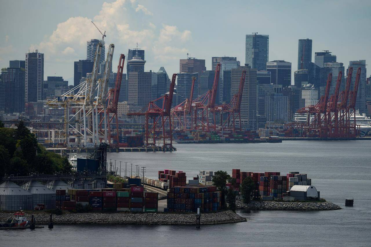 Gantry cranes sit idle above stacks of cargo containers at port during a strike by International Longshore and Warehouse Union Canada workers in the province, in Vancouver, on Wednesday, July 12, 2023. THE CANADIAN PRESS/Darryl Dyck
