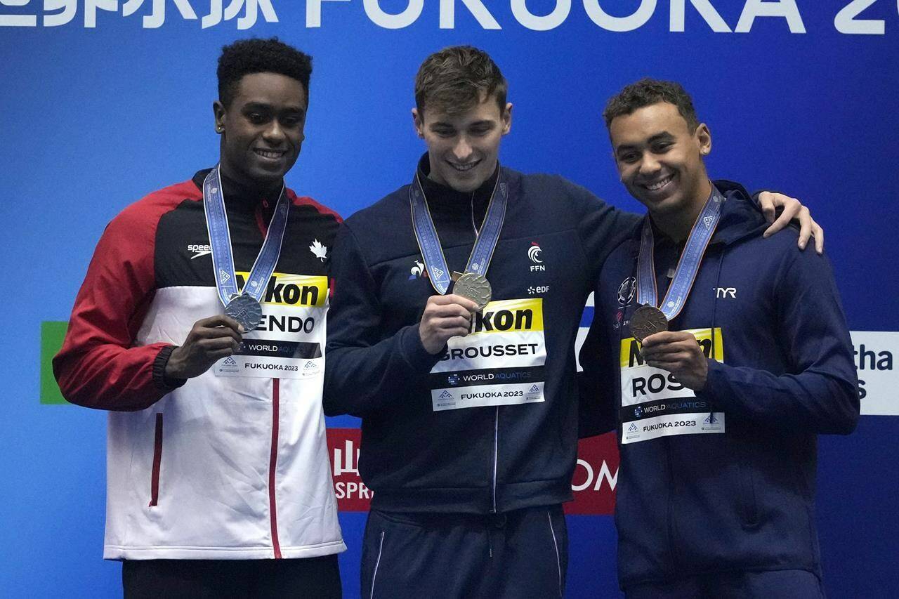 Medalists, from left to right, Josh Liendo of Canada, silver, Maxime Grousset of France, gold, and Dare Rose of the U.S., bronze celebrate during the medal ceremony for the men’s 100m butterfly at the World Swimming Championships in Fukuoka, Japan, Saturday, July 29, 2023. THE CANADIAN PRESS/AP-Lee Jin-man