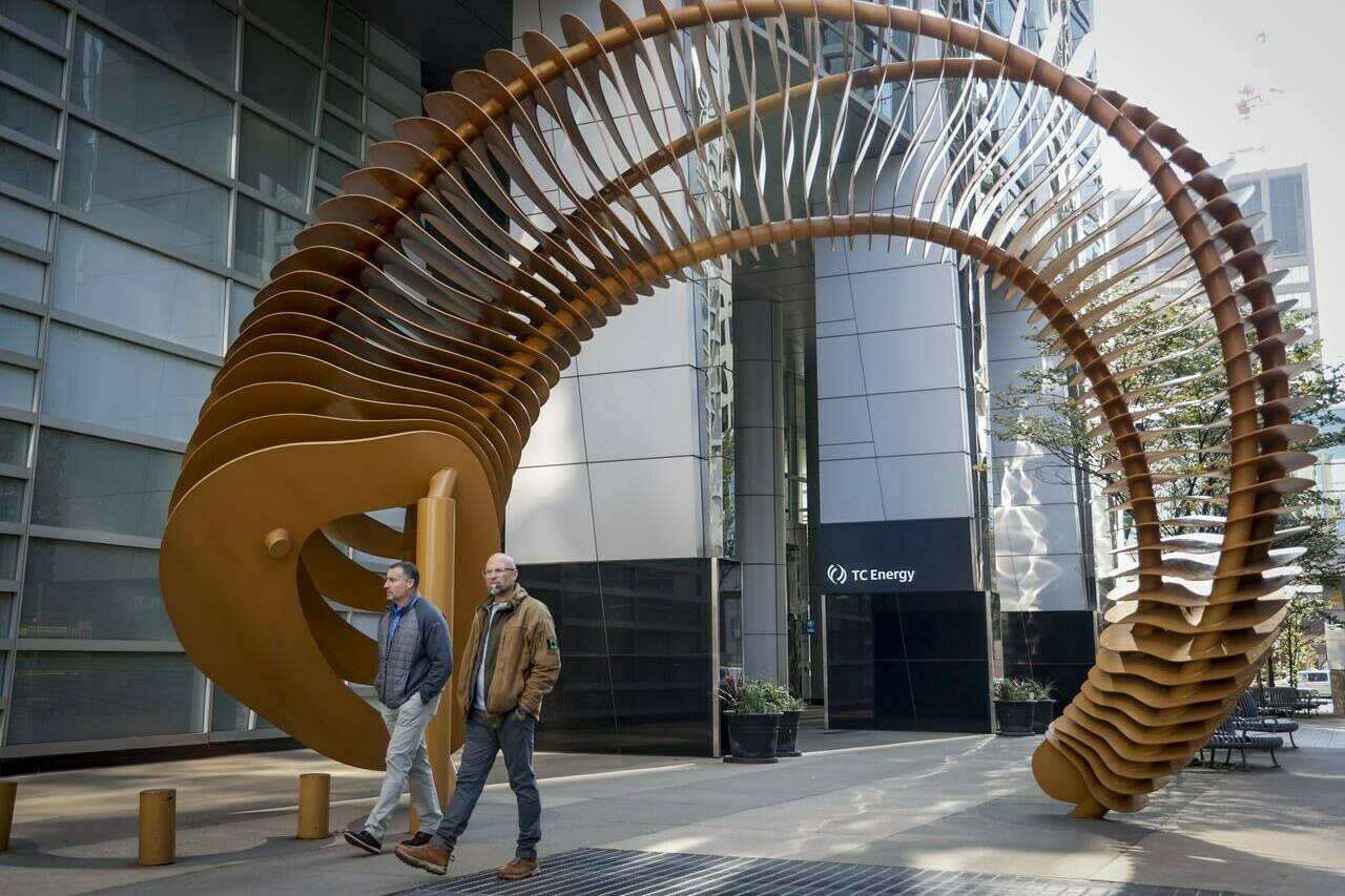 Pedestrians walk past a sculpture outside the TC Energy head office in downtown Calgary, Alta., Friday, Sept. 16, 2022.THE CANADIAN PRESS/Jeff McIntosh