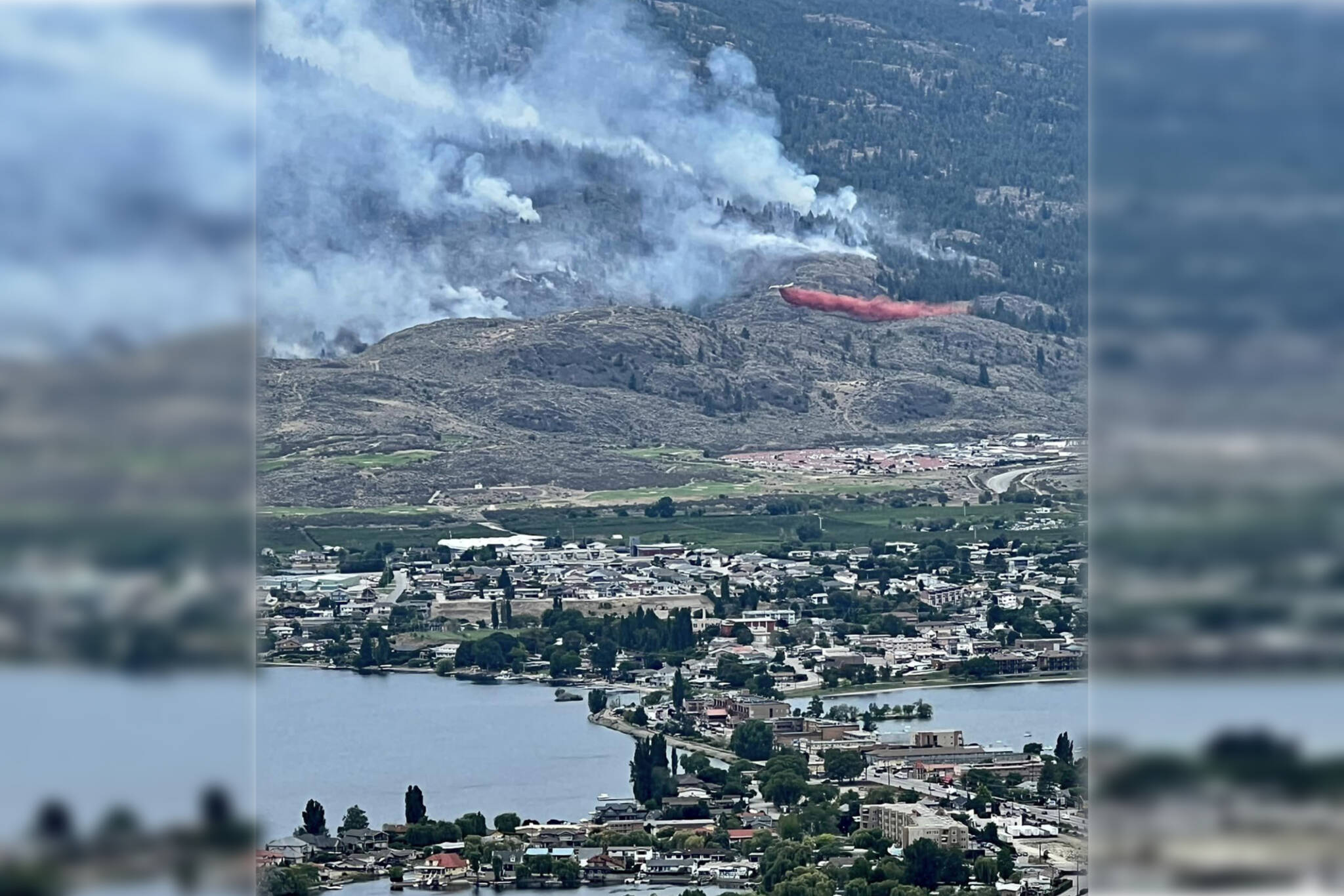Air crews were busy dropping retardent on the flanks of the Eagle Bluff Wildfire on the edge of Osoyoos on July 30. The wildfire has grown dramatically since it first crossed the border on July 29. (Melissa Genberg - Facebook)