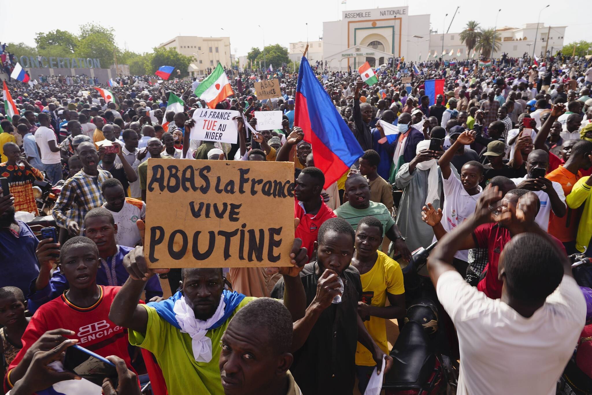 FILE - Nigeriens participate in a march called by supporters of coup leader Gen. Abdourahmane Tchiani in Niamey, Niger, Sunday, July 30, 2023. The French Foreign Ministry says Tuesday, Aug.1, 2023 France is planning an imminent evacuation of people seeking to leave Niger after the coup last week in the former French colony. Poster reads: Down with France, long live Putin.” (AP Photo/Sam Mednick, File)