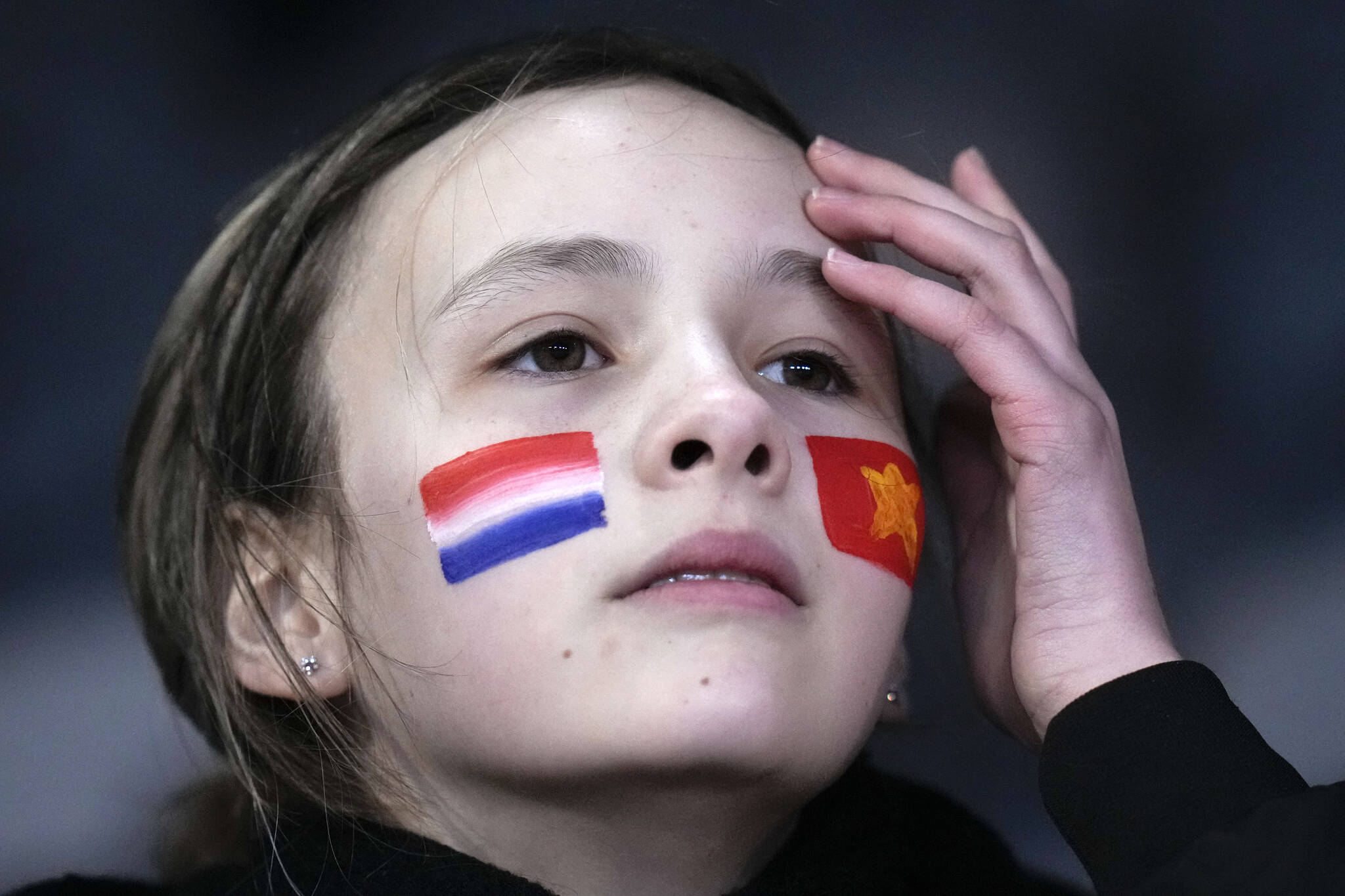 A young supporters wears the flags of Netherlands and Vietnam on her cheeks on the tribune prior to the Women’s World Cup Group E soccer match between Vietnam and the Netherlands in Dunedin, New Zealand, Tuesday, Aug. 1, 2023. (AP Photo/Alessandra Tarantino)