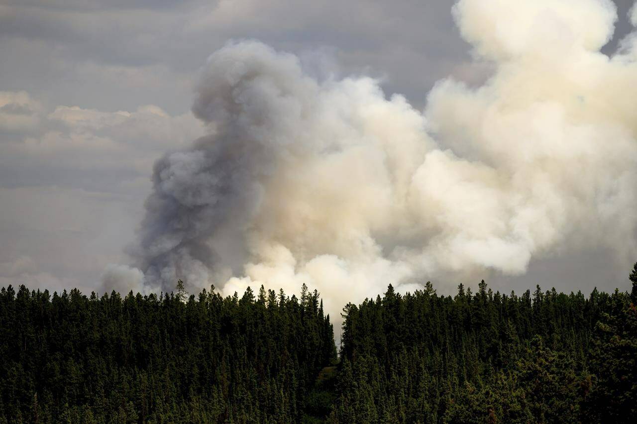 Smoke billows from the Donnie Creek wildfire burning north of Fort St. John, British Columbia, on Sunday, July 2, 2023. The young Ontario firefighter who died last week in British Columbia has been identified as Zak Muise in an online obituary and tribute by the firefighting contractor he worked for. THE CANADIAN PRESS/AP, Noah Berger
