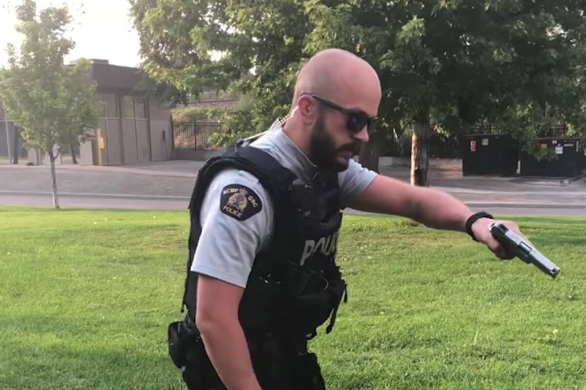 A still from a Facebook video posted July 31, 2023 showing Kamloops RCMP Officer D. Tucker with his pistol drawn. (Twister Love/Facebook)