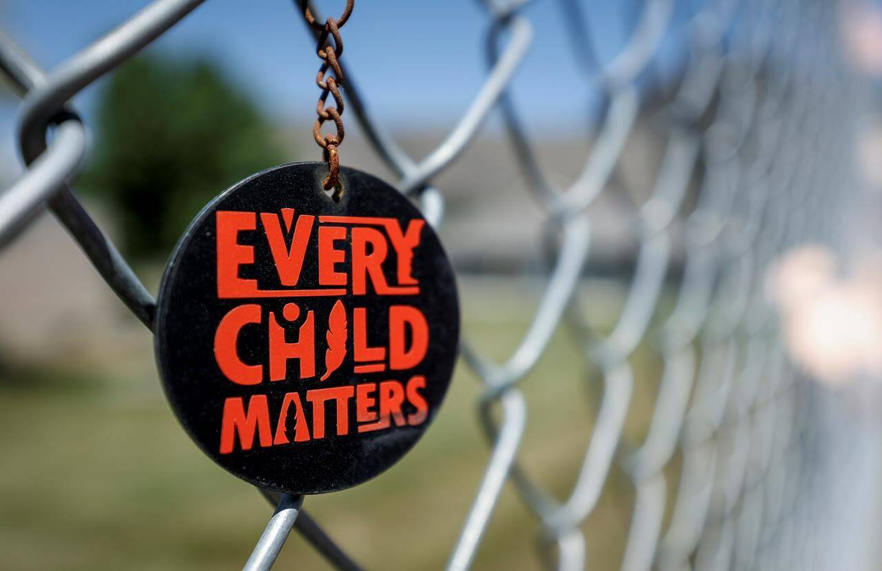 A key chain dangles from a fence as part of a memorial outside the former Kamloops Indian Residential School in Kamloops, B.C., Thursday, June 1, 2023. A Guatemala-based forensic anthropology organization is extending its hand to Indigenous Peoples in Canada looking to potentially recover bodies of children on the grounds of former residential schools. THE CANADIAN PRESS/Jeff McIntosh