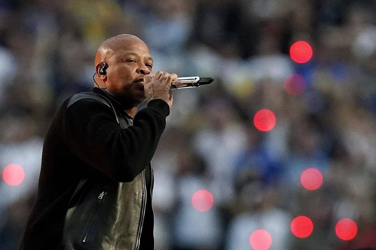 FILE - Dr. Dre performs during the halftime show during the NFL Super Bowl 56 football game, Feb. 13, 2022, in Inglewood, Calif. The signs of hip-hop’s influence are now everywhere from Pharrell Williams becoming Louis Vuitton’s men’s creative director to billion-dollar brands like Dr. Dre’s Beats headphones and retail mainstays like Diddy’s Sean John and the Rocawear line started by Jay-Z. It didn’t start out that way. Companies at first balked at partnering with hip-hop acts because they felt that the genre that appealed to Black and brown teens and young adults didn’t align with their brands. (AP Photo/Steve Luciano, File)