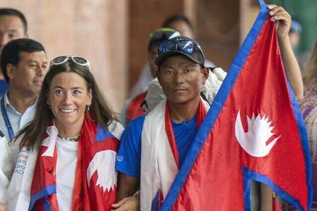 Norwegian climber Kristin Harila, left, and her Nepali sherpa guide Tenjen Sherpa, right, who climbed the world’s 14 tallest mountains in record time, arrive in Kathmandu, Nepal, Saturday, Aug. 5, 2023. Harila and Sherpa shattered the record for the fastest climb of the 14 mountains more than 8,000 meters (about 26,000 feet) high when they topped Mount K2 in Pakistan late last month. The previous record was 189 days, and the pair did it in 92 days. (AP Photo/Niranjan Shrestha)