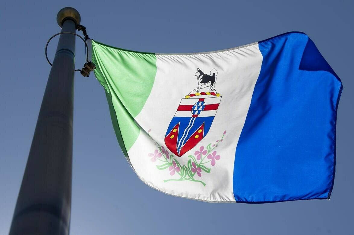 The Yukon provincial flag flies on a flagpole in Ottawa, Monday, July 6, 2020. The remote fly-in community of Old Crow in Yukon has been ordered evacuated due to a weather change that increases the risk of wildfires. THE CANADIAN PRESS/Adrian Wyld