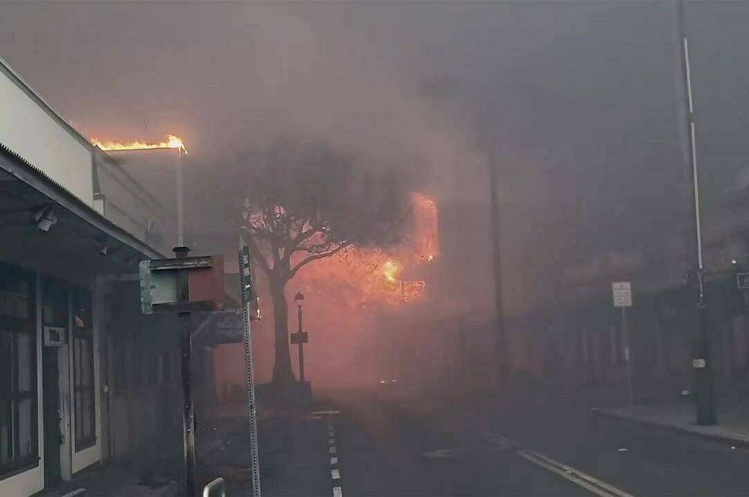 Smoke and flames fill the air from raging wildfires on Front Street in downtown Lahaina, Maui on Tuesday, Aug. 9, 2023. Maui officials say wildfire in the historic town has burned parts of one of the most popular tourist areas in Hawaii. County of Maui spokesperson Mahina Martin said in a phone interview early Wednesday says fire was widespread in Lahaina, including Front Street, an area of the town popular with tourists. (Alan Dickar via AP)