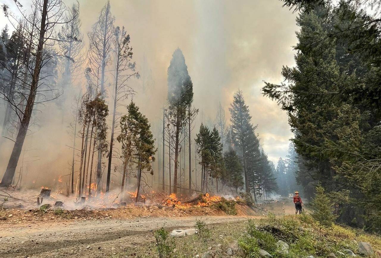 A firefighter works at the Ross Moore Lake wildfire south of Kamloops, B.C., in this July 28, 2023 handout photo. THE CANADIAN PRESS/HO, BC Wildfire Service *MANDATORY CREDIT*