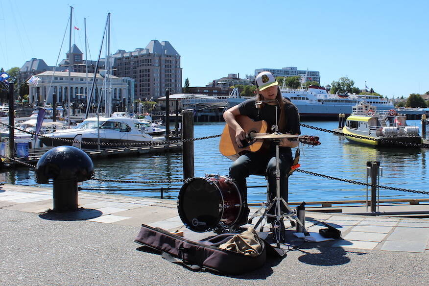 Harbour Nolan, 19, busks on the Inner Harbour Causeway, the location after which he was named. (Natasha Baldin/News Staff)