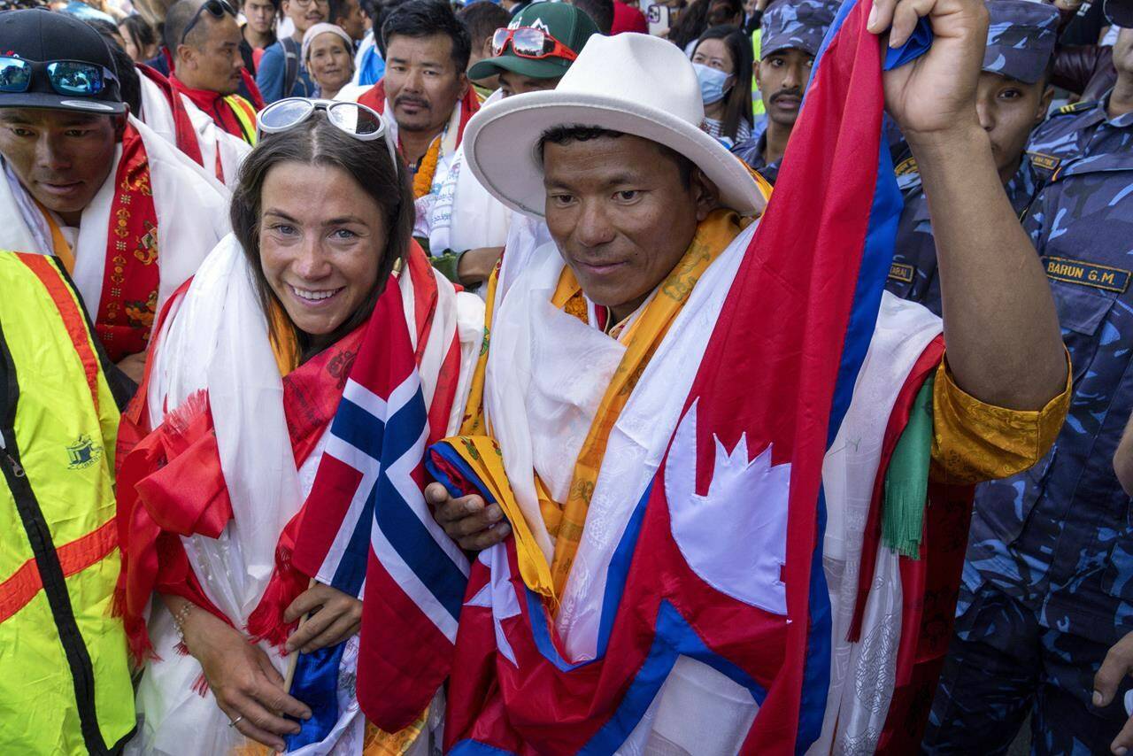 FILE - Norwegian climber Kristin Harila, left, and her Nepali sherpa guide Tenjen Sherpa, right, who climbed the world’s 14 tallest mountains in record time, arrive in Kathmandu, Nepal, Saturday, Aug. 5, 2023. A Pakistani mountaineer said Saturday, Aug. 12, 2023, that an investigation has been launched into the death of a Pakistani porter during Harila’s record quest. (AP Photo/Niranjan Shrestha, File)