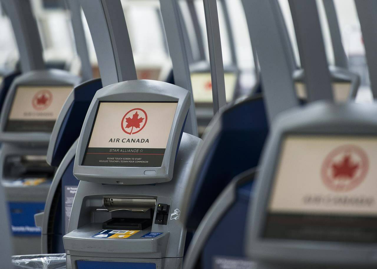 An Air Canada ticketing station is shown at Pearson International Airport in Toronto on Wednesday, April 8, 2020. Air Canada says earnings reached heights not seen since before the COVID-19 pandemic amid high travel demand and pricier fares, and despite low on-time performance numbers. THE CANADIAN PRESS/Nathan Denette
