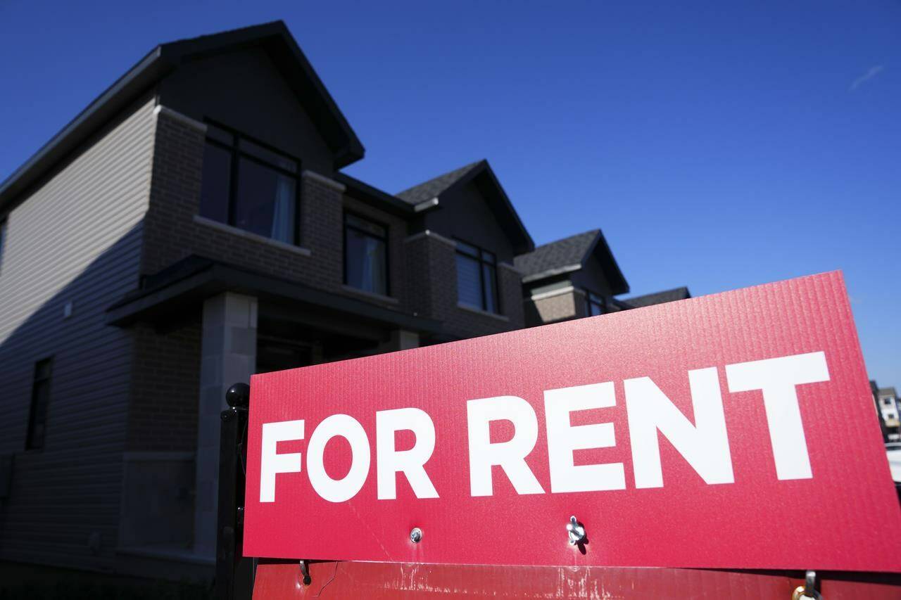 A for rent sign is displayed on a house in Ottawa on Friday, Oct. 14, 2022. A new report says Canada’s average asking rent reached a new record in July. THE CANADIAN PRESS/Sean Kilpatrick