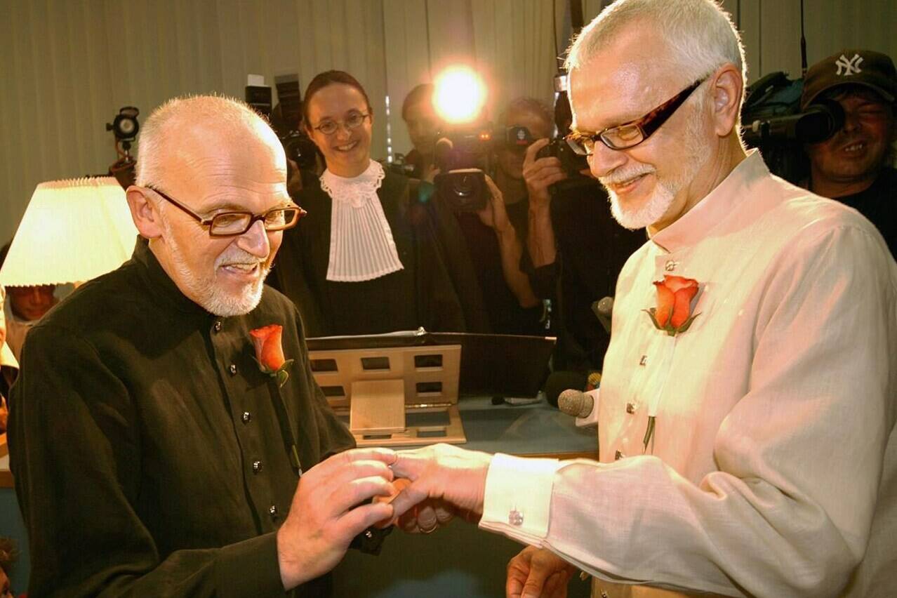 Roger Thibault, one half of the first same-sex couple married in a civil ceremony in North America, died Friday at the age of 77. Thibault, left, places a wedding band on his husband Theo Wouters during their wedding at the Montreal Courthouse, Thursday, July 18, 2002. THE CANADIAN PRESS/Anthony Peters