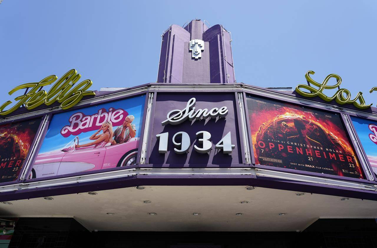 The marquee of the Los Feliz Theatre features the films “Barbie” and “Oppenheimer,” Friday, July 28, 2023, in Los Angeles. (AP Photo/Chris Pizzello)