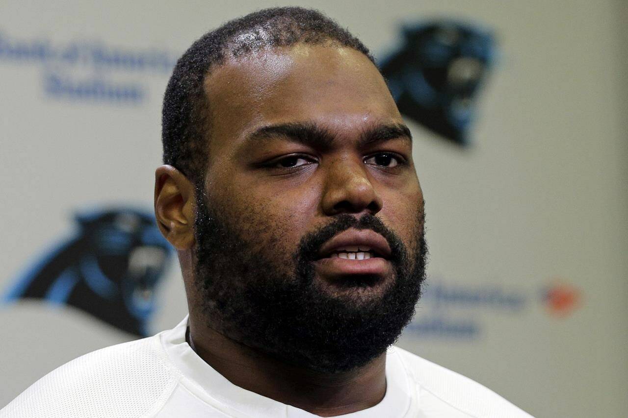 FILE - Carolina Panthers’ Michael Oher speaks to the media during the first day of their NFL football offseason conditioning program in Charlotte, N.C., April 20, 2015. Oher, the former NFL tackle known for the movie “The Blind Side,” filed a petition Monday, Aug. 14, 2023, in a Tennessee probate court accusing Sean and Leigh Anne Tuohy of lying to him by having him sign papers making them his conservators rather than his adoptive parents nearly two decades ago.(AP Photo/Chuck Burton, File)