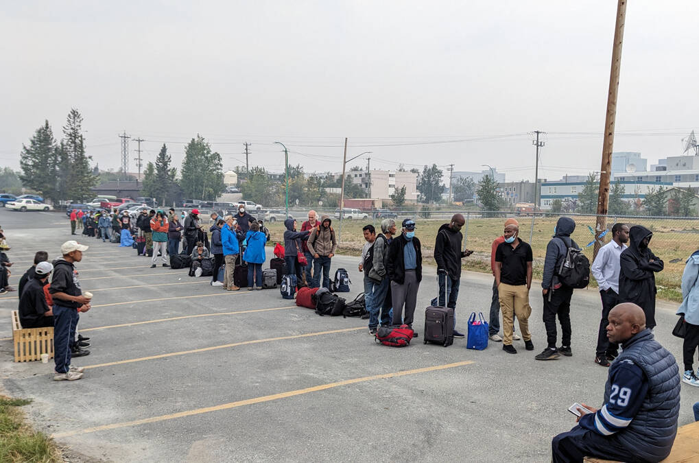 People without vehicles lineup to register for a flight to Calgary, Alberta in Yellowknife on Thursday, August 17, 2023. Prime Minister Justin Trudeau is expected to convene an urgent meeting with ministers and senior officials today as residents of the capital of Northwest Territories are ordered to evacuate the area because of an encroaching wildfire. THE CANADIAN PRESS/Bill Braden