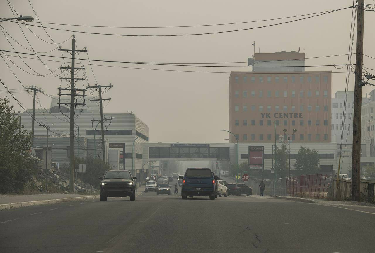 Heavy smoke from nearby wildfires fills the sky in Yellowknife on Tuesday, August 15, 2023. Residents of the capital of the Northwest Territories and two neighbouring First Nation communities have been ordered to evacuate by Friday because of an encroaching wildfire. THE CANADIAN PRESS/Angela Gzowski