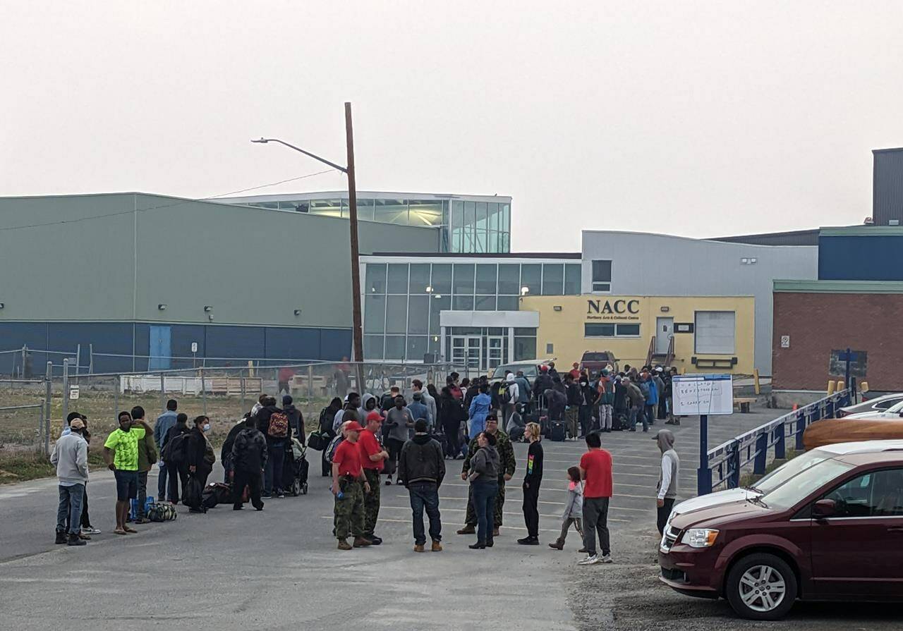 People without vehicles line up to register for a flight to Calgary in Yellowknife on Thursday, Aug. 17, 2023. THE CANADIAN PRESS/Bill Braden