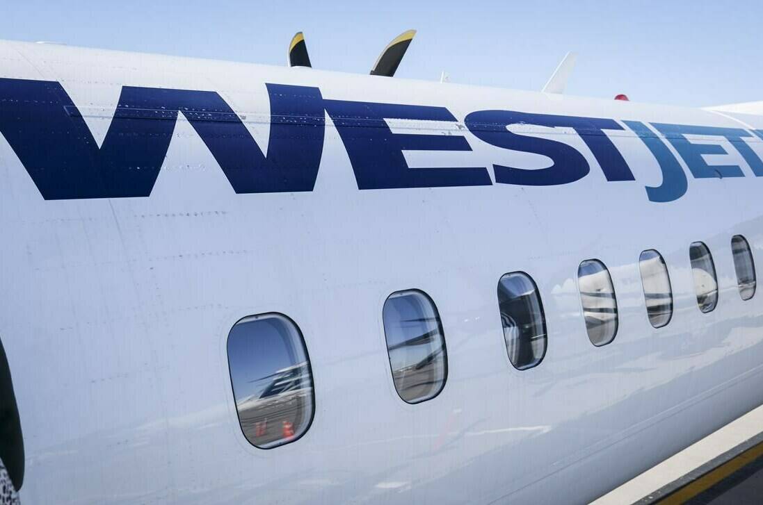 WestJet says it’s adjusting prices and adding capacity to help with evacuation efforts from Yellowknife. A WestJet plane waits at a gate at Calgary International Airport in Calgary, Alta., Wednesday, Aug. 31, 2022.THE CANADIAN PRESS/Jeff McIntosh