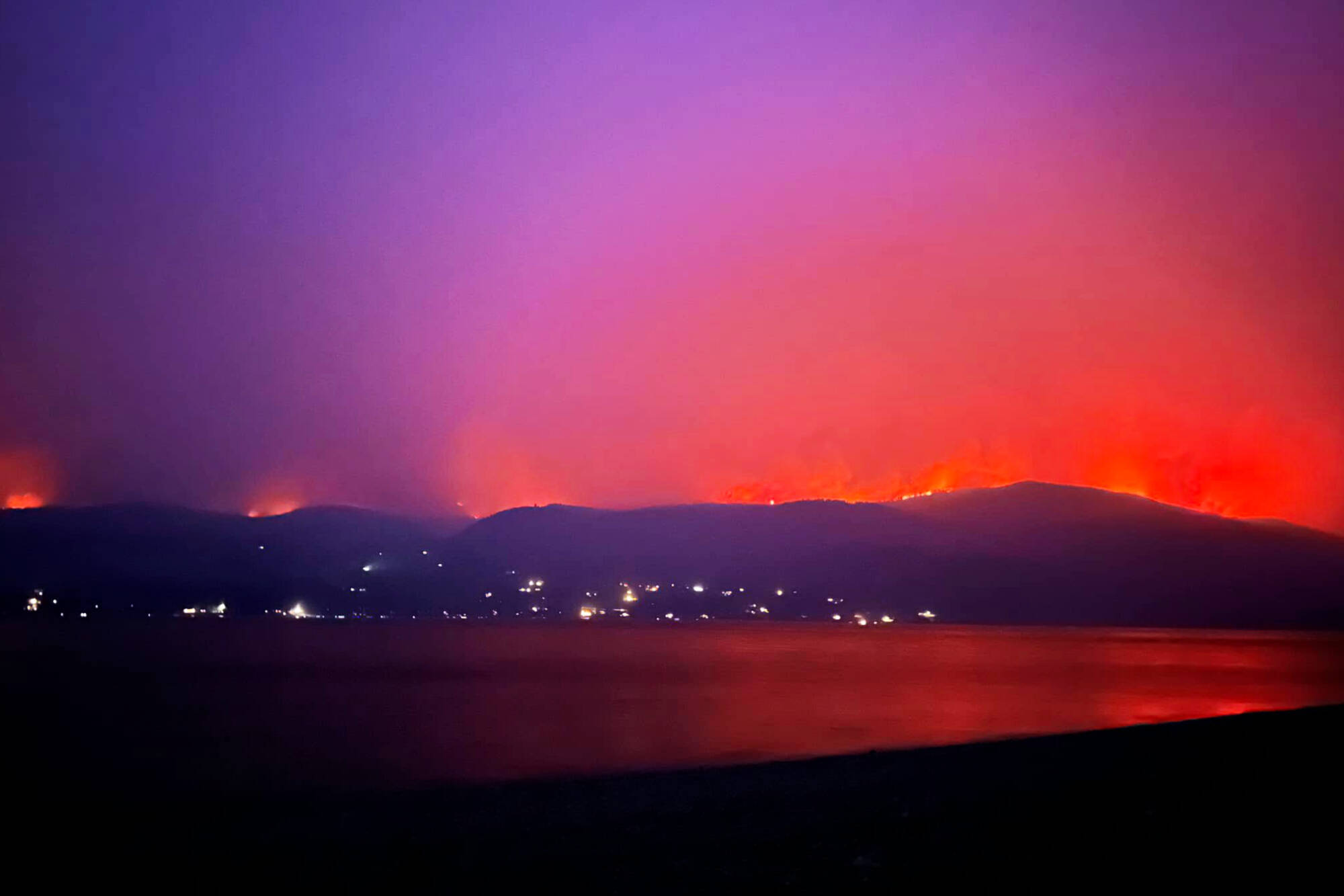 A 10-kilometre planned ignition could be seen burning in the hills behind Scotch Creek on Thursday night, Aug. 17, 2023. (Sasha Ellenna Pellow//Facebook photo)