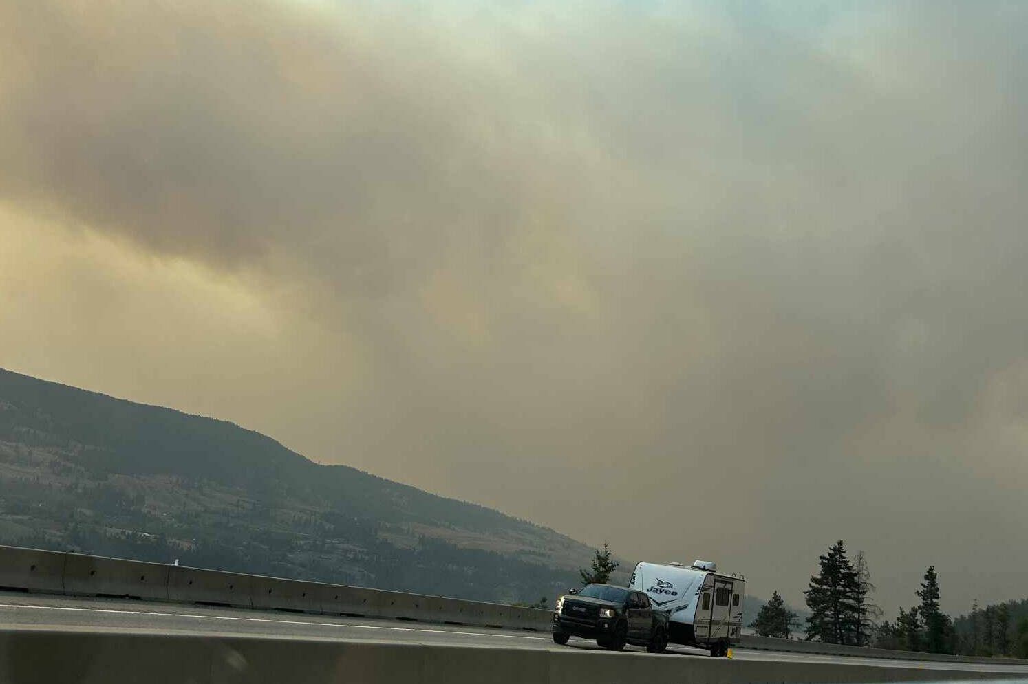 Thick wildfire smoke can be seen from Highway 97 near Vernon. (Contributed)