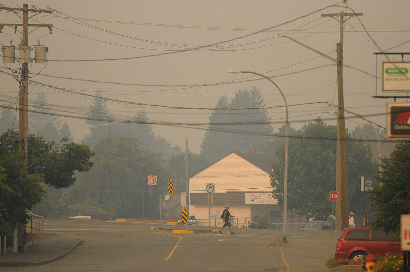 A pedestrian walks along Yale Road at Alexander Avenue in Chilliwack on Sunday, Aug. 20, 2023. Environment Canada’s air quality health index value for the Eastern Fraser Valley was 10+ or ‘very high risk’ that day due to smoke from nearby wildfires. (Jenna Hauck/ Chilliwack Progress)