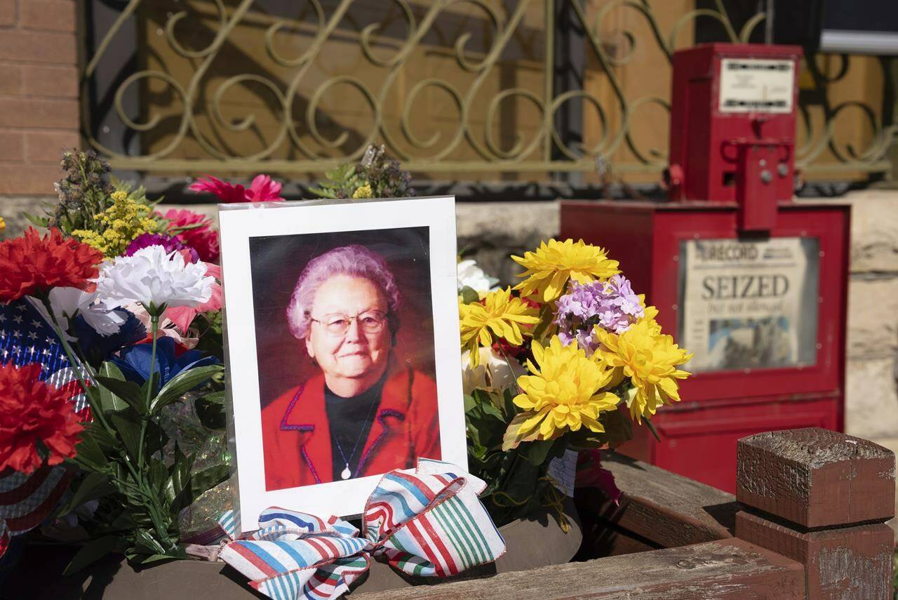 A makeshift shrine is set up in front of the Marion County Record in Marion, Kan. on Saturday, Aug. 19, 2023 with a picture of the newspaper’s co-owner Joan Meyer and flowers. (Jaime Green /The Wichita Eagle via AP)