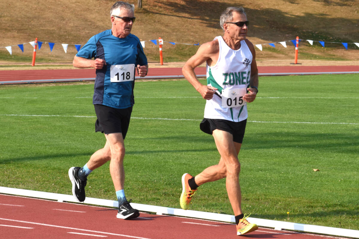 Doug Miller (right) and Dean Robert battle it out in the men’s 5000 metres during BC 55-Plus Games action on Wednesday (Aug. 23). (Ben Lypka/Abbotsford News)