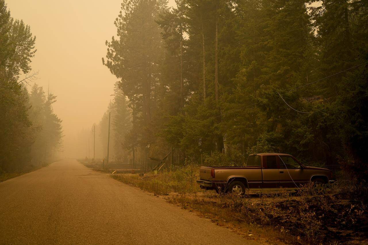 Downed power lines are seen on a pickup truck in an area burned by the Lower East Adams Lake wildfire, in Scotch Creek, B.C., on Sunday, August 20, 2023. Firefighters in British Columbia’s southern Interior continue to battle a number of major blazes, having been aided by ample rainfall that fell yesterday over the Okanagan and Shuswap regions.THE CANADIAN PRESS/Darryl Dyck
