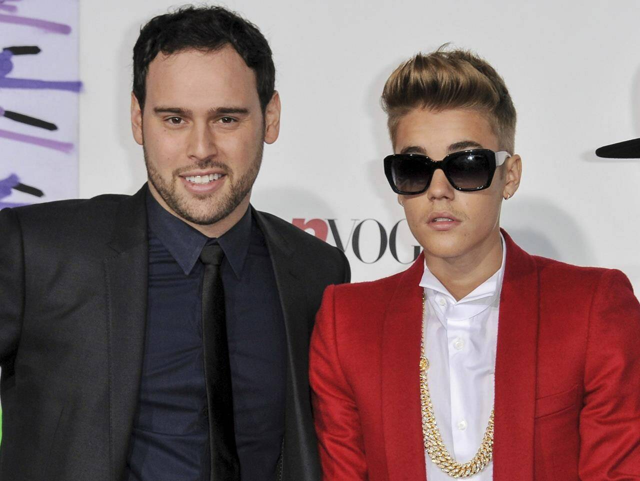 FILE - Music executive Scooter Braun, left, appears with Justin Bieber at the World Premiere of “Justin Bieber’s Believe” in Los Angeles on December 2013. (Photo by Richard Shotwell/Invision/AP, File)