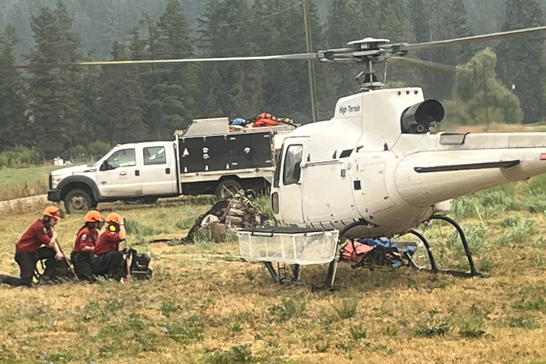 Firefighters needed to be shuttled by helicopter to the blaze burning in Spallumcheen in tough terrain. (Township of Spallumcheen photo)