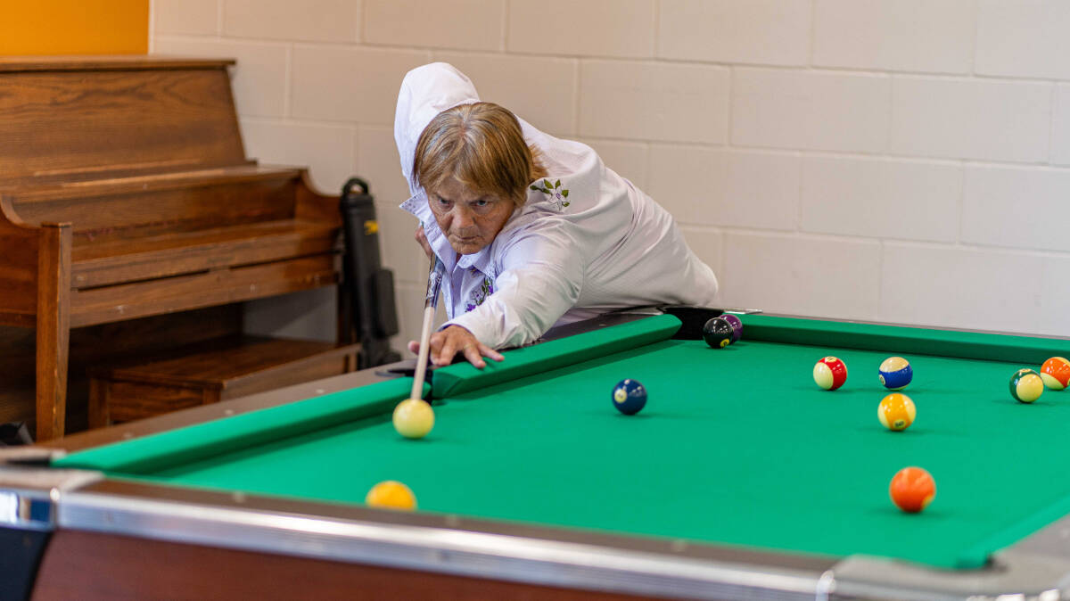 An 8-Ball player lines up his shot. (BC 55-Plus Games photo team)