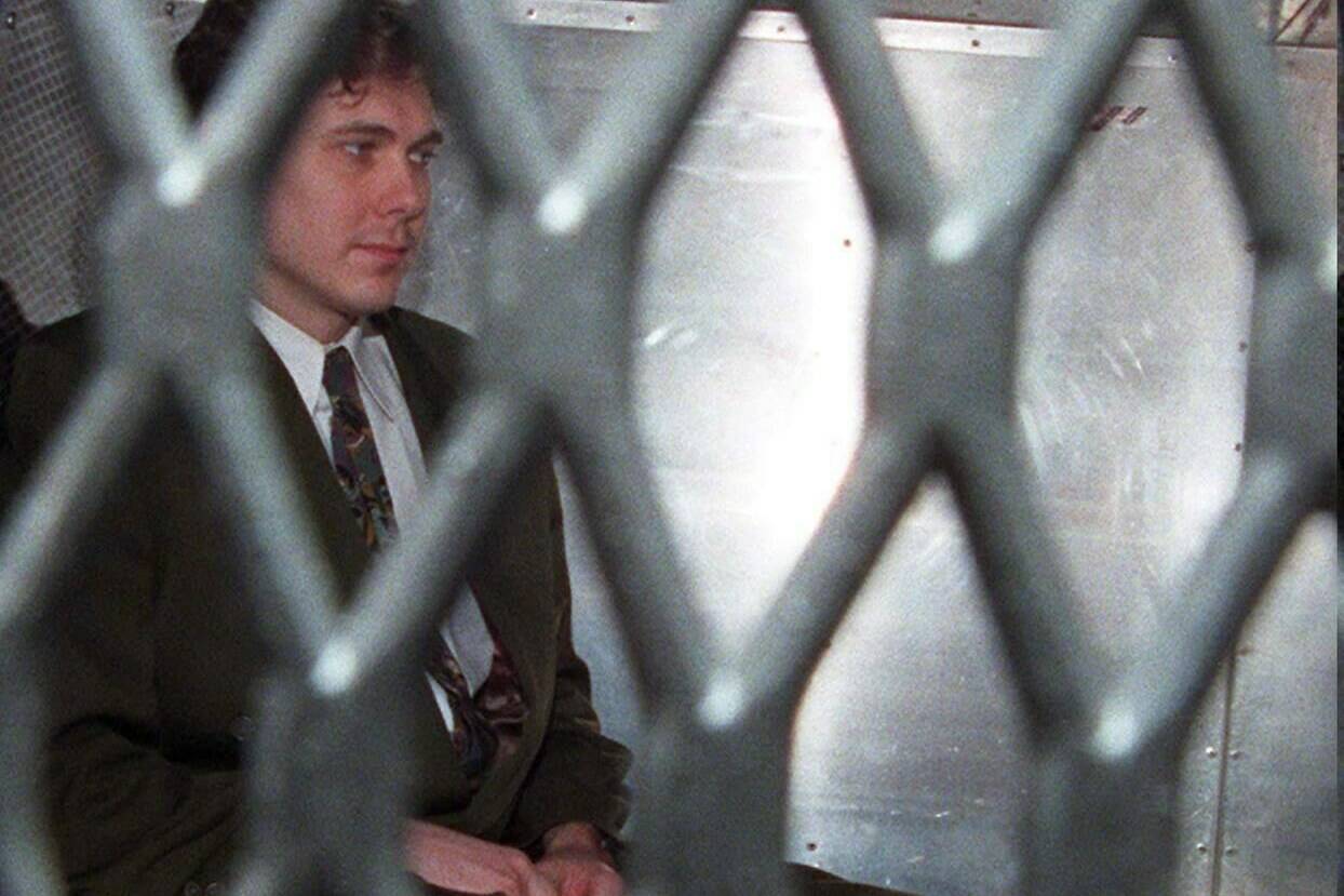 Paul Bernardo arrives at the provincial courthouse in the back of a police van in Toronto in a November 3, 1995 file photo. THE CANADIAN PRESS/Frank Gunn